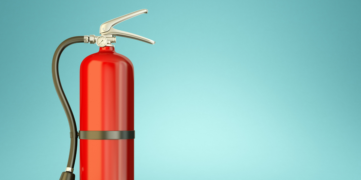 Fire extinguisher against a green background